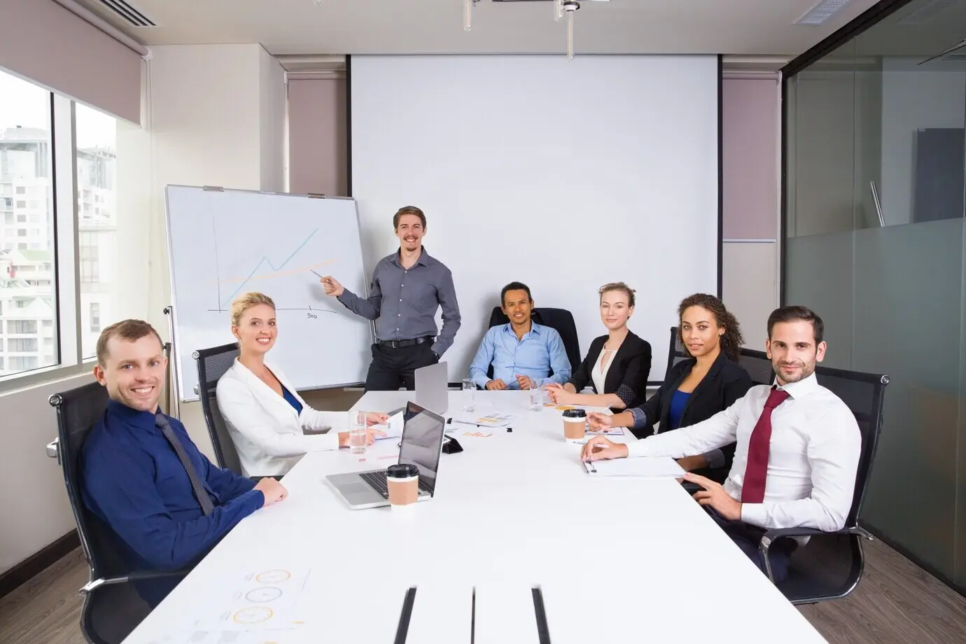 Smiling business people posing in a meeting room