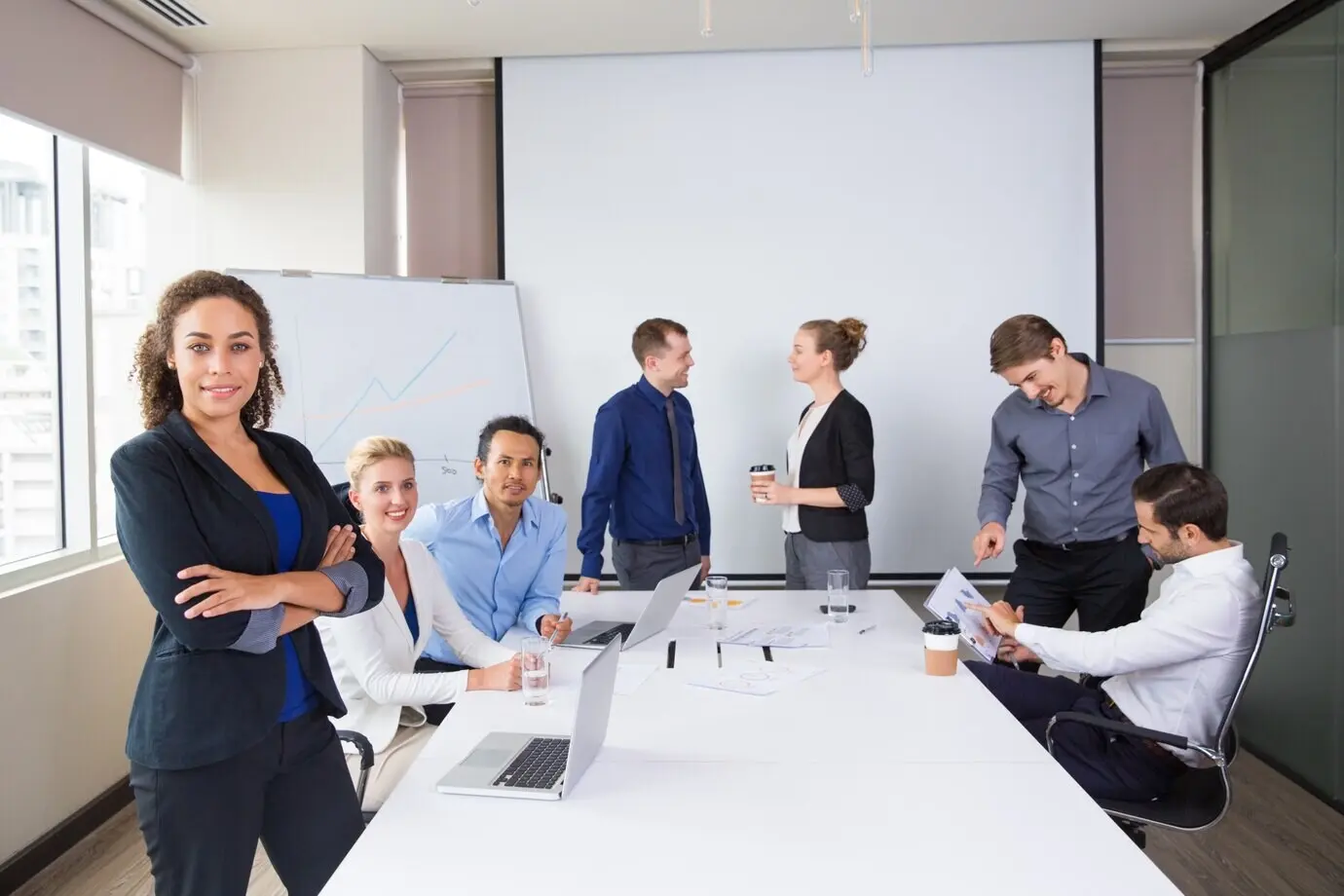 Smiling businesspeople posing in a meeting room.