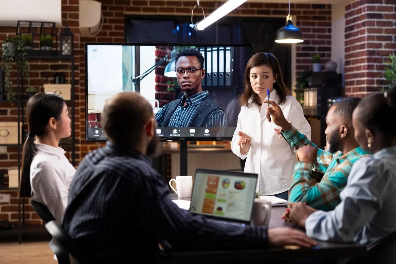 A startup team meeting with their remote manager.